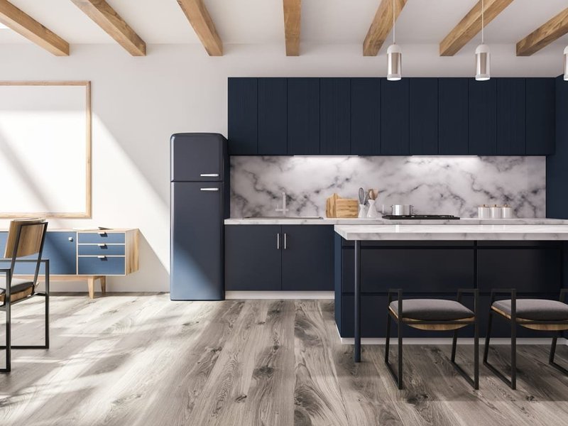 gray kitchen cabinets in contrast with brown hardwood floor from Beseda Flooring Saint Charles, MO