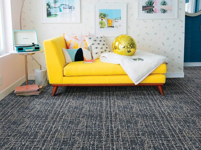 yellow couch on a gray carpet floor from Beseda Flooring Saint Charles, MO